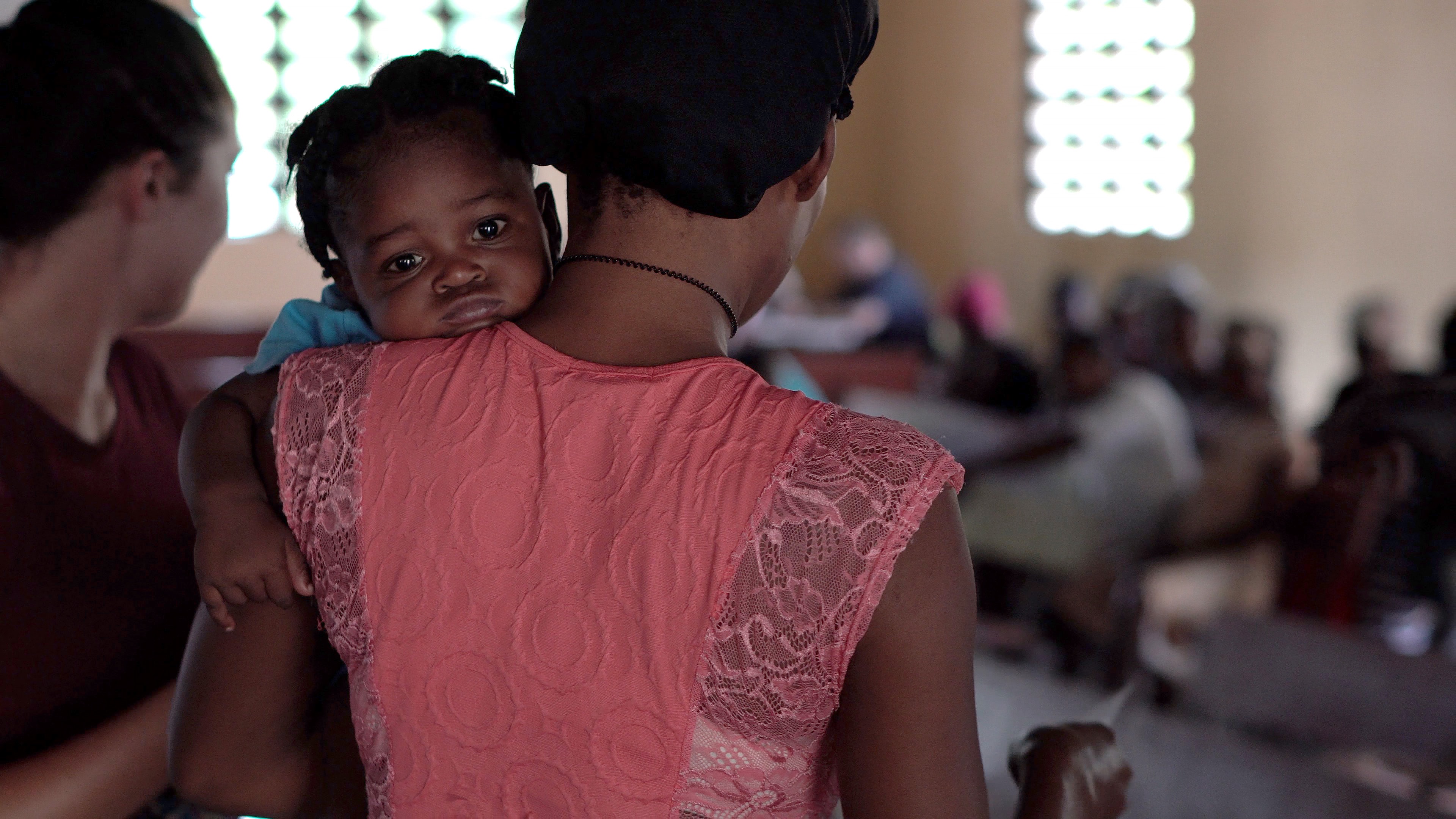 A mother holding a toddler